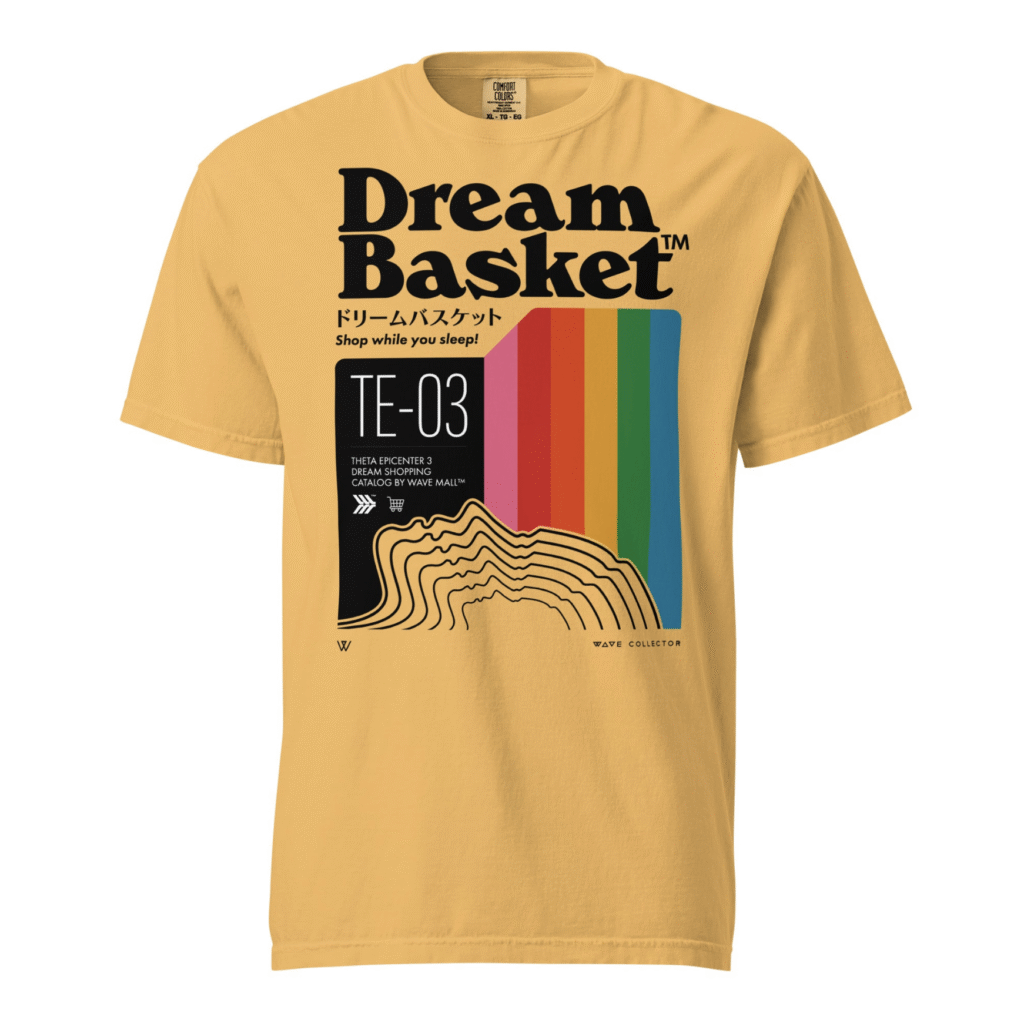 A mustard yellow shirt that says "Dream Basket" and "Shop While You Sleep." It has multiple outlines of a face and a rainbow coming up from the face.